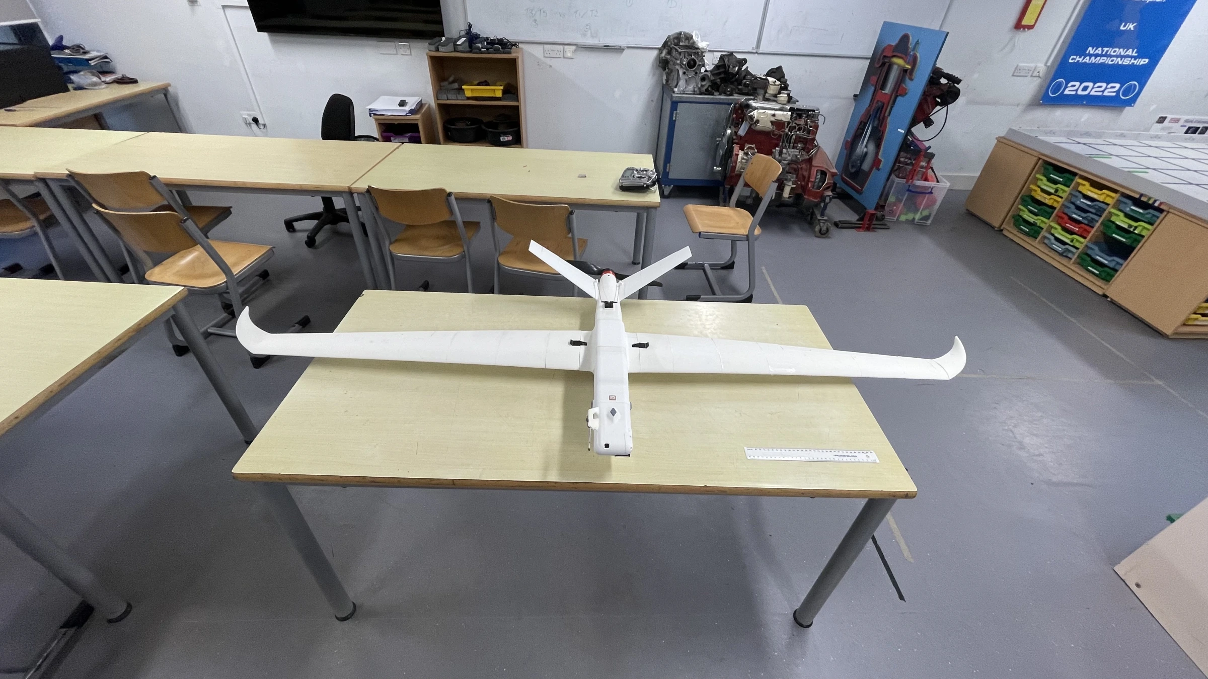Completed fixed-wing prototype with detachable wings on a workshop table.