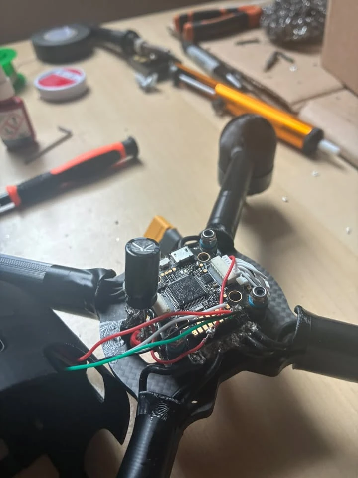 Exposed flight electronics and wiring inside the FPV quadcopter.
