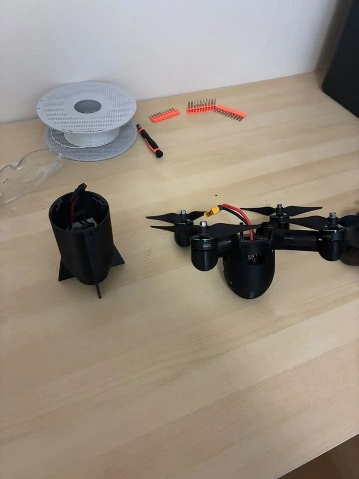 FPV quadcopter with its removable rear shell beside the airframe.